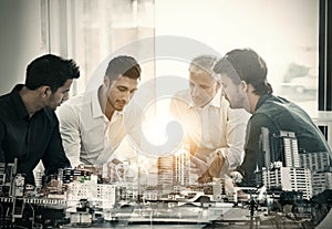 Knowing your business is the first step towards success. Cropped shot of a group of businessmen having a meeting around