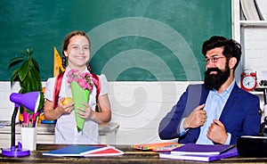 Knowledge day congratulations. Girl adorable pupil with backpack carry bouquet flowers for teacher. School holiday