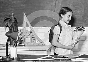 Knowledge day congratulations. September 1. Back to school. Girl adorable pupil with backpack carry bouquet flowers for