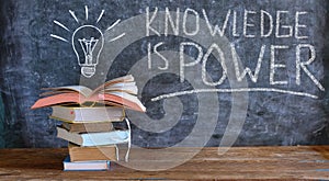 Knowledge is power, books and blackboard with drawing of a lightbulb,education,learning,reading,knowledge,back to school concept.