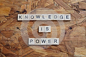 knowledge is power text on wooden square, motivation quotes.