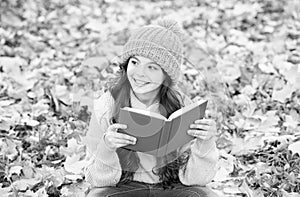 Knowledge is seed that grows when you read. Happy kid read book sitting on autumn leaves. Knowledge day. September 1