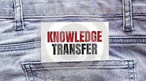 KNOWLEDGE TRANSFER, words on a white paper stuck out from jeans pocket. Business concept