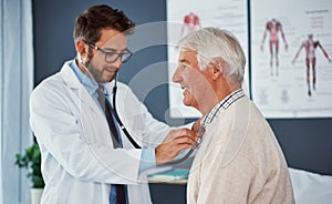 He knows hes in good hands with his doctor. a doctor examining a senior patient with a stethoscope in a clinic.