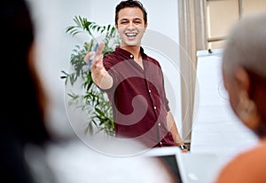 He knows how to inspire and uplift his team. Shot of a young businessman using a whiteboard while giving a presentation