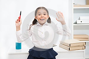 She knows right answer. Child girl wears school uniform standing excited face expression. Schoolgirl smart child looks