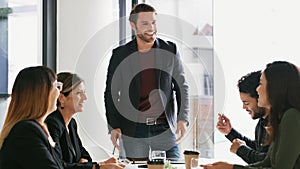 He knows what to say to inspire his team. a young businessman giving a presentation to his colleagues in an office.