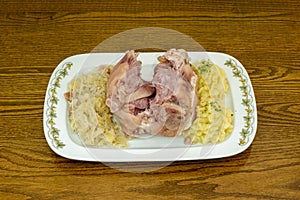 The knuckle is usually marinated or precooked in a garlic and caraway brine