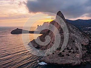 Koba-kaya mountain in sea in Crimea, large rock at beautiful sunset and seascape nature landscape, aerial panoramic view from