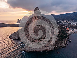 Koba-kaya mountain in sea in Crimea, large rock at beautiful sunset and seascape nature landscape, aerial panoramic view