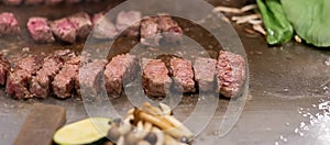 Kobe beef steak or high quality steak on hot plate pan during Teppanyaki Japanese Chef cooking and grilling in restaurant.