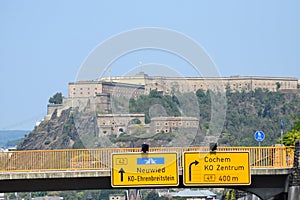 Koblenz, Germany - 08 12 2020: Festung Ehrenbreitstein with a road sign to Neuwied, Cochem and the centre of Koblenz