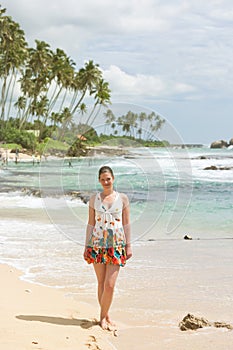 Koggala Beach, Sri Lanka - A woman standing on the sand at Koggala Beach