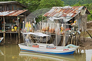 View to the fishermen`s village with stilt residential houses and fishing boats in Koh Chang, Thailand.