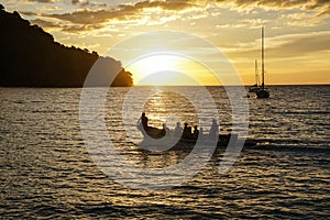 Koh kood beach thailand, sunset boat orange sky people on boat, kayaking silhouette