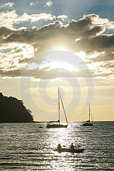 Koh kood beach thailand, sunset boat orange sky people on boat, kayaking silhouette