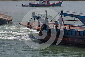 KOH PHANGAN, THAILAND - AUGUST 31, 2013: Ferry boat taking off in Phangan island port.