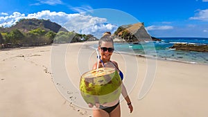 Koka Beach - A girl with a coconut on an idyllic beach