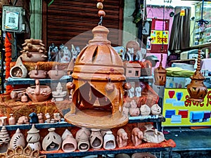 stock photo of beautiful handmade designer hanging clay lantern kept on street