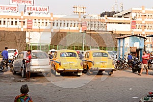 Kolkata`s yellow Ambassador car cabs parked in the prepaid taxi booth outside Sealdah station platform main entrance gate. Sealda