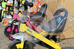 Colorful children`s scooter and kids toy for sell on an open shop, at Esplanade, Kolkata.