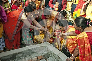 The Hindu devotees are busy in a holy ritual in front of a Homa Kund.