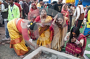 The Hindu devotees are busy in a holy ritual in front of a Homa Kund.