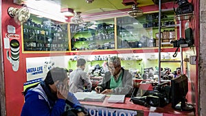 People working in a  camera repair workshop in the streets of the city of Kolkata