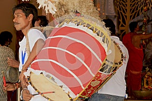 Traditional drum or music instrument decoration with feather and drummer display during famous hindu festival