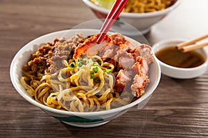 Kolo Mee is a Sarawak Malaysian dish of dry noodles tossed in a savoury pork and shallot mixture, topped off with fragrant fried photo