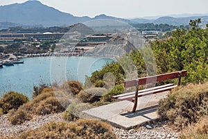 Kolymbia beach with the rocky coast and bench with a view