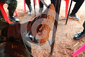 Kombat shoes of soldiers invaded the road, muddy soil