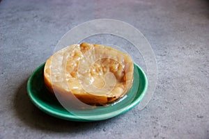 Kombucha mother or SCOBY on plate on kitchen countertop photo