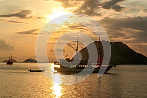 Komodo - Sunset over magical island and some boats on the sea