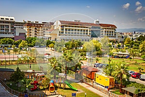 Konakli, Turkey - August 18, 2017: Tropical resort hotels top view. Children`s playground on site on sunny day.