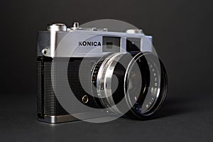 Konica vintage rangefinder camera auto s 1.6 35mm on a black background.