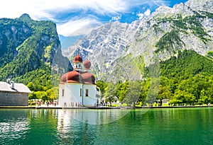 Konigsee lake with st Bartholomew church surrounded by mountains, Berchtesgaden National Park, Bavaria, Germany photo