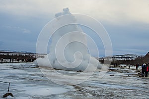 Konungshver geyser steams- Strokkur geyser erupts in the background, in Iceland