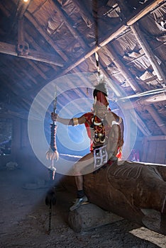 Konyak Warrior inside hid hut at Hornbill Festival,Nagaland,India