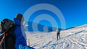 Kor Alps - Couple in snowshoes on snow covered mountains of Kor Alps, Lavanttal Alps, Carinthia Styria, Austria. Winter wonderland