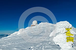 Kor Alps - Frozen directional path marks at austro control Goldhaube on snow capped mountain peak Grosser Speikogel