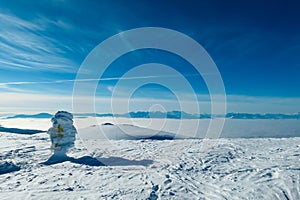 Kor Alps - Frozen directional path marks with panoramic view of Karwanks and Julian Alps seen from Grosser Speikkogel