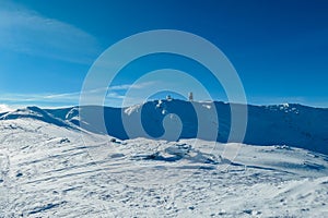 Kor Alps - Idyllic snow covered alpine meadow with scenic view of majestic mountain peak Grosser Speikogel in Kor Alps