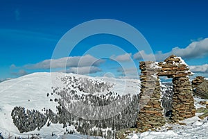 Kor Alps - Snow covered massive unique stones display on mountain peak Steinmandl in Kor Alps, Lavanttal Alps