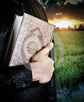 Koran in hand - holy book of Muslims  public item of all muslims