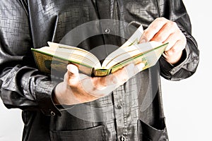 Koran in hand - holy book of Muslims ( public item of all muslims )