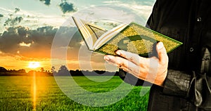 Koran in hand - holy book of Muslims  public item of all muslims