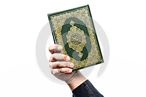 Koran in hand ,Quran in hand - holy book of Muslims , on white background