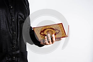 Koran in hand ,Quran in hand - holy book of Muslims , on white background