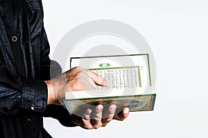 Koran in hand ,Quran in hand - holy book of Muslims , on white background